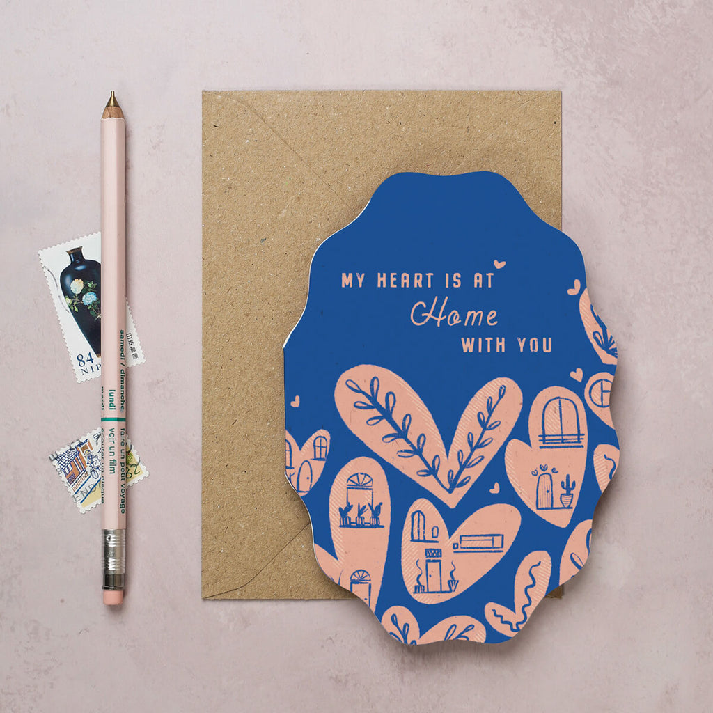 A Love card designed by I Am Roxanne for the Folksy collection featuring pink heart homes on a cerulean blue background and die cut card shape