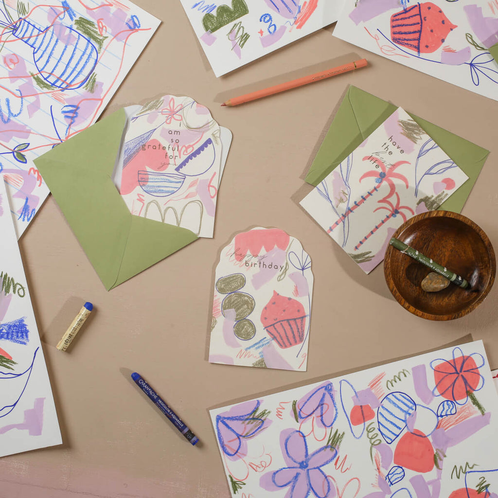 a flat lay of the painterly collection with hand illustrated sketches